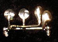 Clef double maillechort avec axe et boules,  finition polie